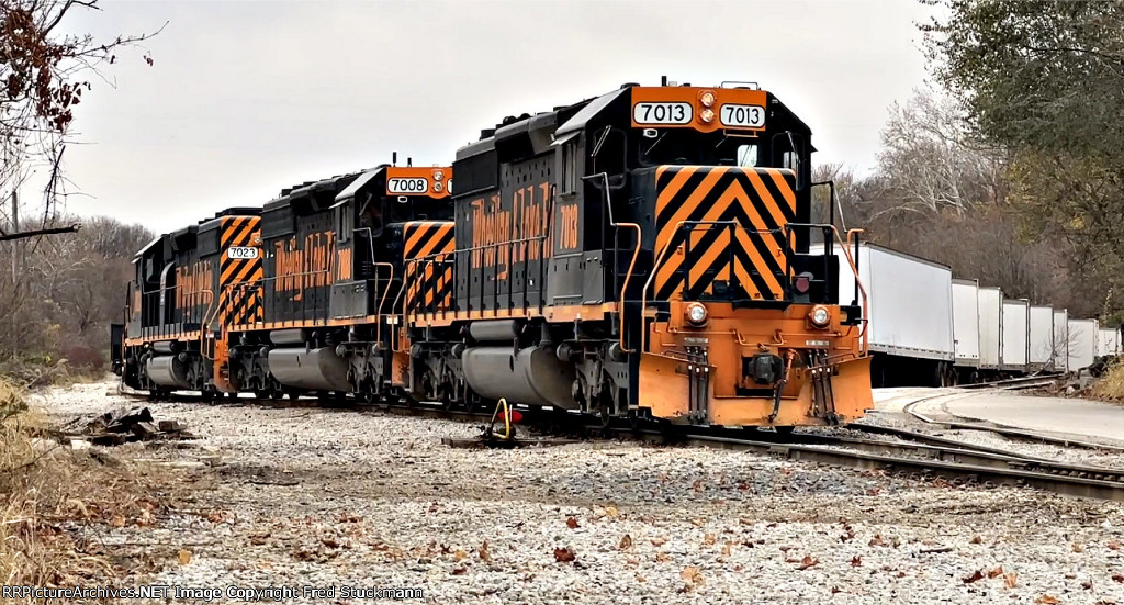 WE 7013 reaches into the siding to gather up her train.